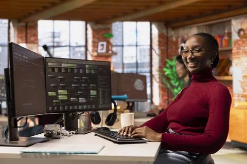Portrait of upbeat programmer working in innovative startup office Stock Photos
