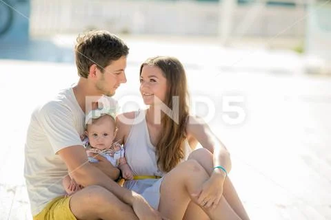 A Portrait from vacation. Happy family with kid walking together outside. Stock Photos