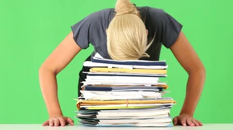 Portrait of very stressed businesswoman overwhelmed with large pile of work Stock Footage