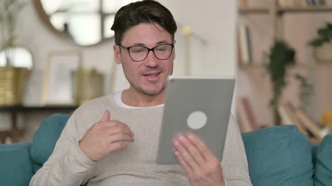 Portrait of Video Call on Tablet by Middle Aged Man at Home 스톡 동영상 142381327