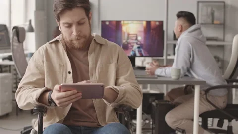 Portrait of Video Game Developer with Tablet PC in Wheelchair Video stock 172193012