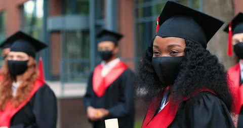 Portrait view of the cute multiracial student woman wearing protective mask Stock Photos