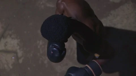 Portrait view hands in gloves hitting boxing bag 스톡 동영상 115914741