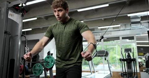 Portrait view of the man training arms with trx fitness strips in gym. Sport man Stock Footage 158931095