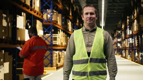 Portrait of warehouse worker in a modern logistics distribution center Stock Footage 332905433