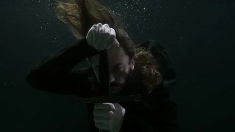 Portrait of a warrior man with a long beard underwater with a sword in his hands Stock-Footage 194423330