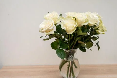 Portrait white frame mockup on table.Modern vase with rosesScandinavian inter Stock Photos