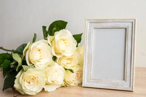 Portrait white frame mockup on table.Modern vase with rosesScandinavian interior Stock Photos