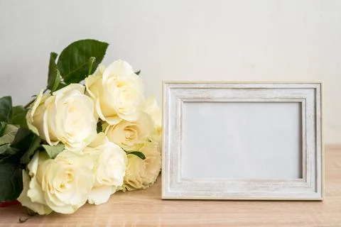 Portrait white frame mockup on table.Modern vase with rosesScandinavian interior Stock Photos