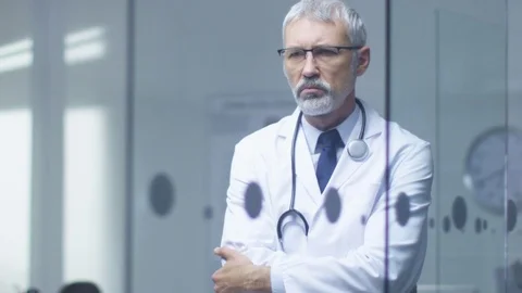Portrait of a White Haired Senior Doctor Thinking about Patient's Diagnosis. Stock Footage