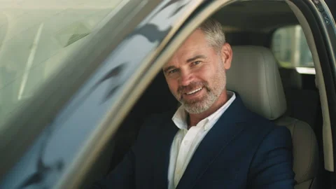 Portrait wide angle of happy smiling male sitting in automobile cabin and Stock Footage 235924901