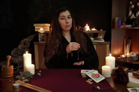 Portrait of witch against of esoteric objects used for healing and purifying. Stock Photos