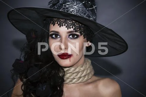 Portrait of a witch with a rope throat. halloween concept Stock Photos