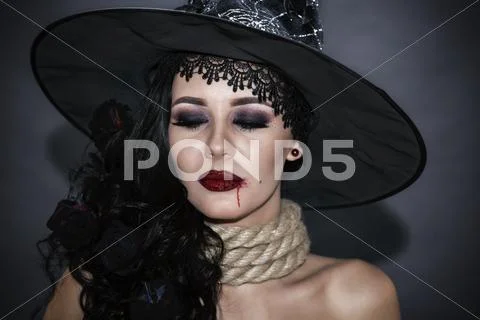 Portrait of a witch with a rope throat. halloween concept Stock Photos