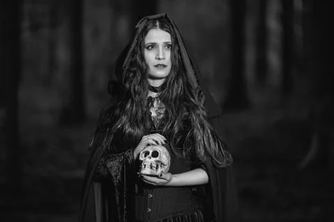 Portrait of a witch with a skull Stock Photos