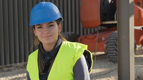Portrait of woman apprentice standing on construction site Stock Footage 123215949