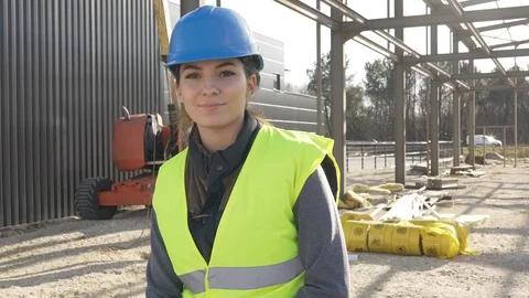 Portrait of woman apprentice standing on construction site Stock Footage 123216298