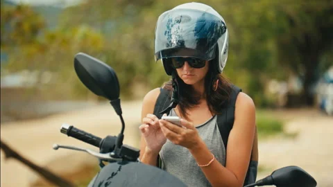 Portrait of woman biker using the map application on the smartphone Stock Footage 88673743