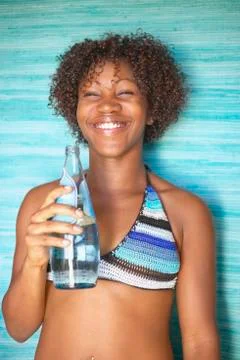 Portrait of woman in bikini with bottled water Stock Photos