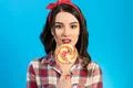 The portrait of the woman with a candy on the blue background Photo
