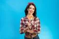 The portrait of the woman with a candy on the blue background Photo
