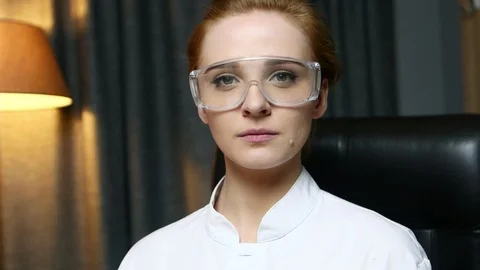 Portrait of woman computer IT engineer in goggles seriously looking at camera. Stockbeeldmateriaal 103462505
