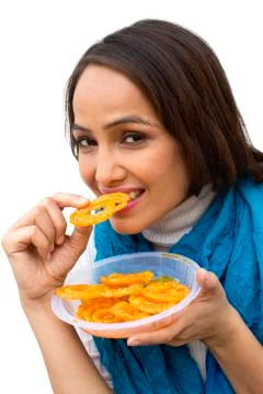Portrait of a woman eating jalebi Stock Photos