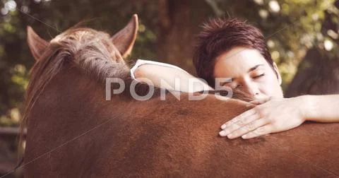 Portrait of a woman is embracing her horse Stock Photos