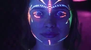 Portrait Of Woman With Ethnic Pattern, Neon Makeup In Ultraviolet Light Stock Footage