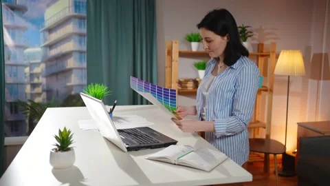 Portrait woman freelancer work standing desk work in the living room Stock Footage 221925657