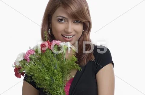 Portrait of a woman holding bouquet of Carnation flowers Stock Photos