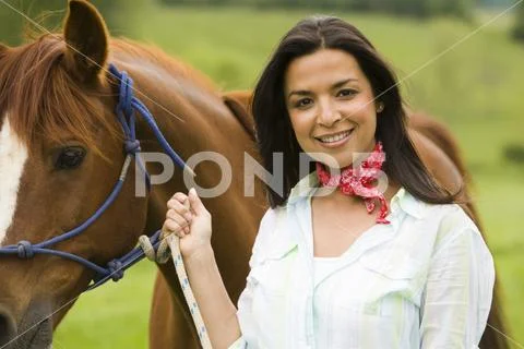 Portrait of a woman holding the reins of a horse Stock Photos