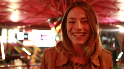 Portrait of woman looking at camera and laughing in amusement park Stock Footage 59556245