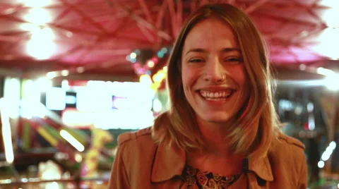 Portrait of woman looking at camera and laughing in amusement park Stock Footage 59556247