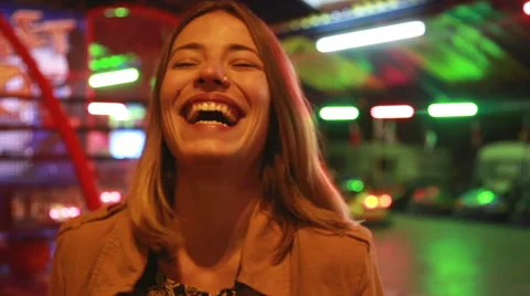 Portrait of woman looking at camera and laughing in amusement park Stock Footage 59556248
