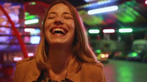 Portrait of woman looking at camera and laughing in amusement park Stock Footage 59556254
