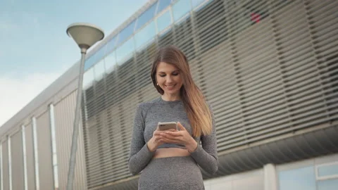 Portrait woman looking at smartphone while running outdoor. Close-up Of A Young Stock Footage 155221500