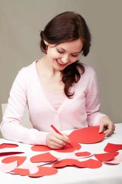 Portrait of a woman signing valentine cards Stock Photos