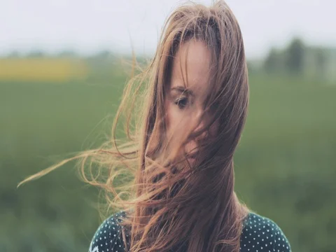 Portrait of Woman Standing on the Wind. SLOW MOTION 4K DCi. Stock Footage