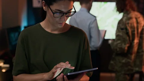 Portrait of Woman Using Digital Tablet in Military Command Center Stock Footage 343742259