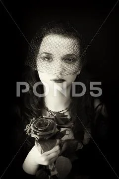 Portrait of woman in the veil with a bouquet of roses Stock Photos