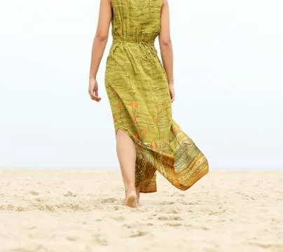Portrait of a woman walking barefoot at the beach Stock Photos