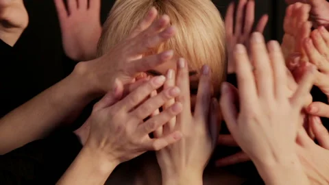 Portrait of a womans face hidden in a multitude of hands. Stock Footage 88537972