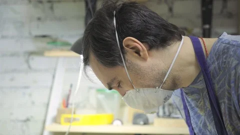 Portrait of a woodworker in a mask while working Stock Footage 102858773