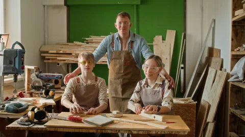 Portrait of Woodworking Instructor and Two Teenagers in Carpentry Workshop Stock Footage 334432665