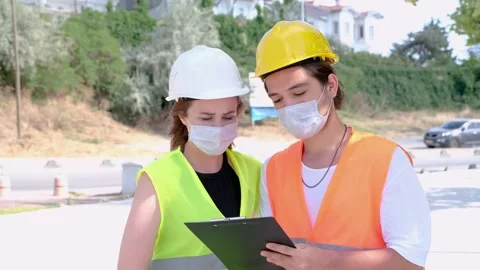 Portrait of worker and engineer wearing face masks checking production process Video stock 136858014