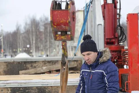 Portrait of a worker in a black hat unloading Fotos Stock