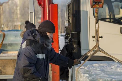 Portrait of a worker in a black hat unloading 스톡 사진