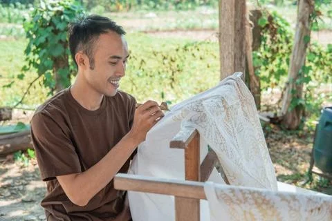 Portrait of a worker drawing batik pattern Stock Photos