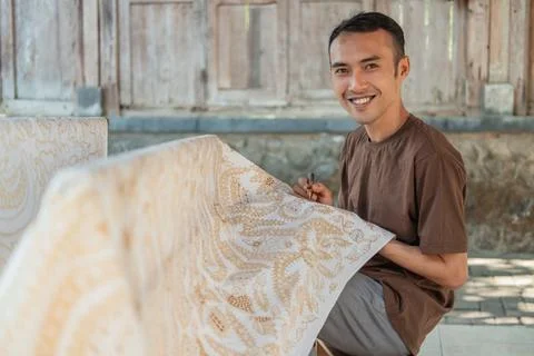 Portrait of a worker drawing batik pattern 스톡 사진